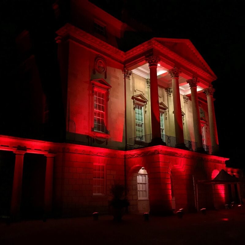 Front facade of the Holburne Museum at night lit up in red lighting