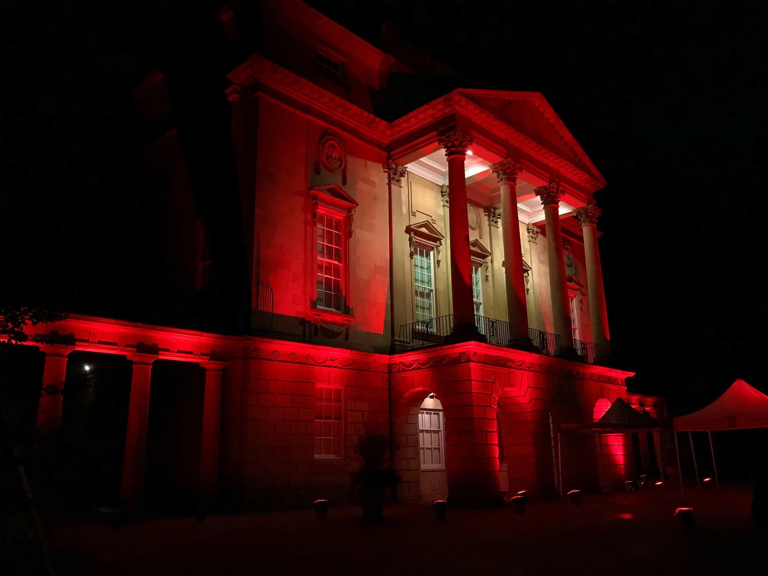Front facade of the Holburne Museum at night lit up in red lighting