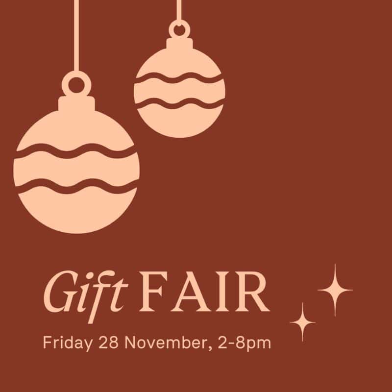 A brown background with two peach baubles and Gift Fair wording