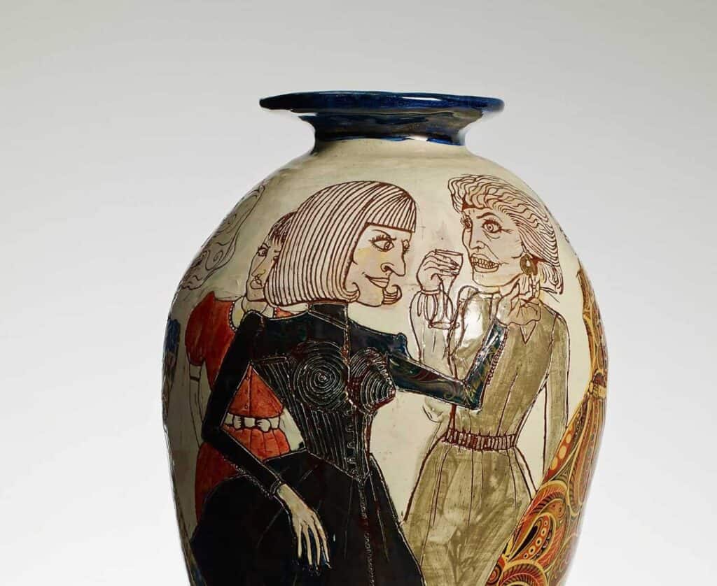 A vase with two women etched into it, drinking and talking