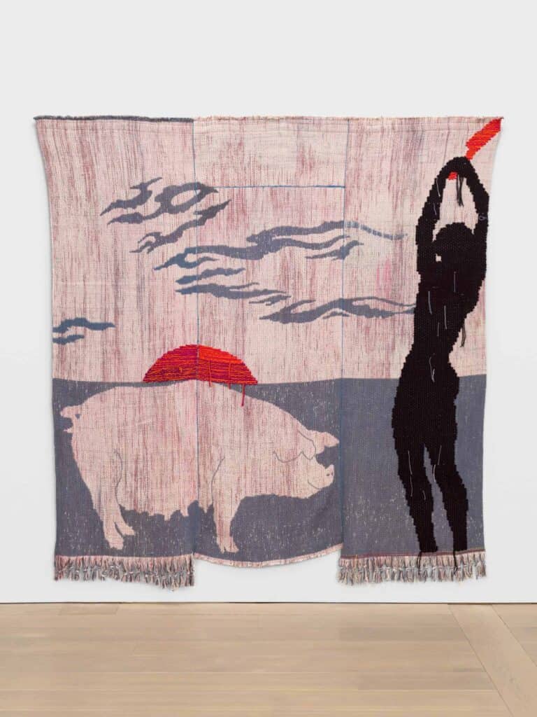 A quilt showing a pink pig in the foreground with an orange setting sun in the background, next to a silhoutte of a person with their arms raised above their head, about to slaughter the pig