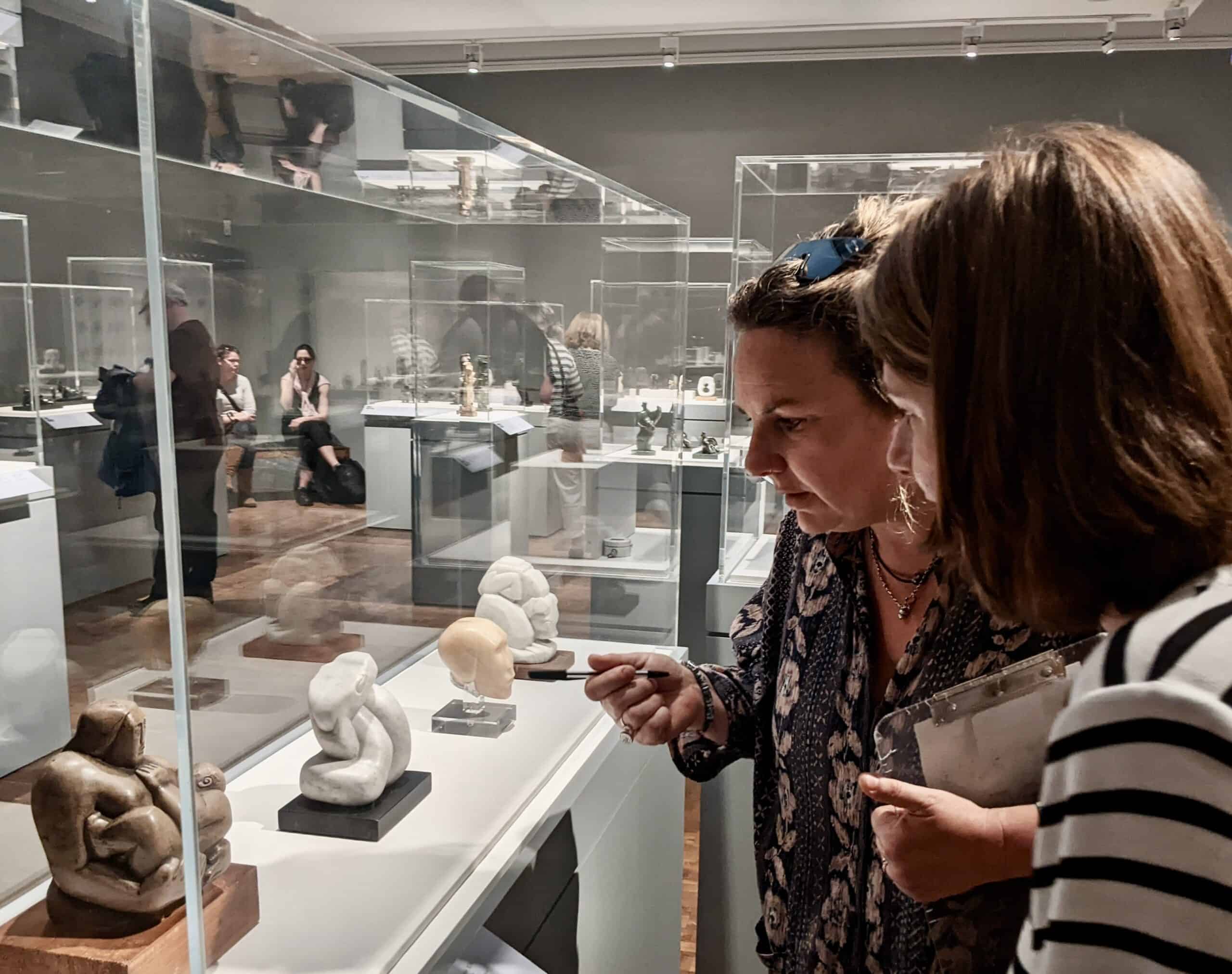 2 ladies looking at a museum display.