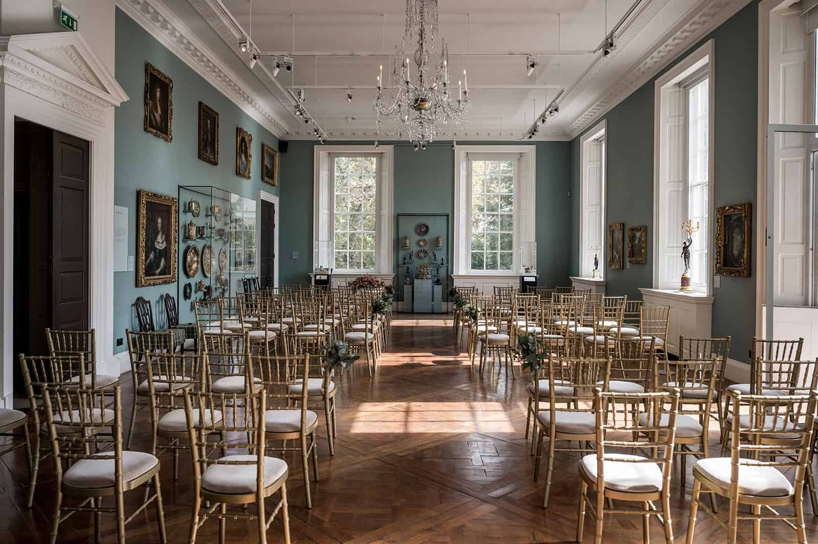 Photo showing the Ballroom set up with rows of gold chairs for a wedding reception