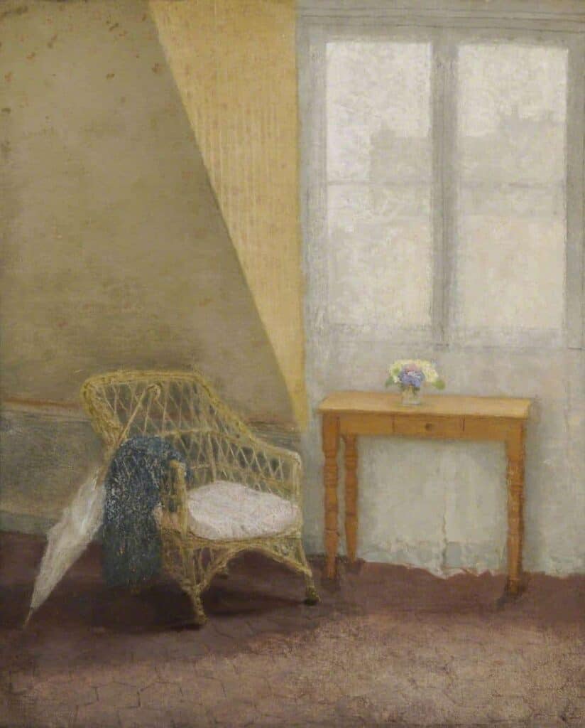 A wicker chair next to a table by a window in typical Gwen John muted colours