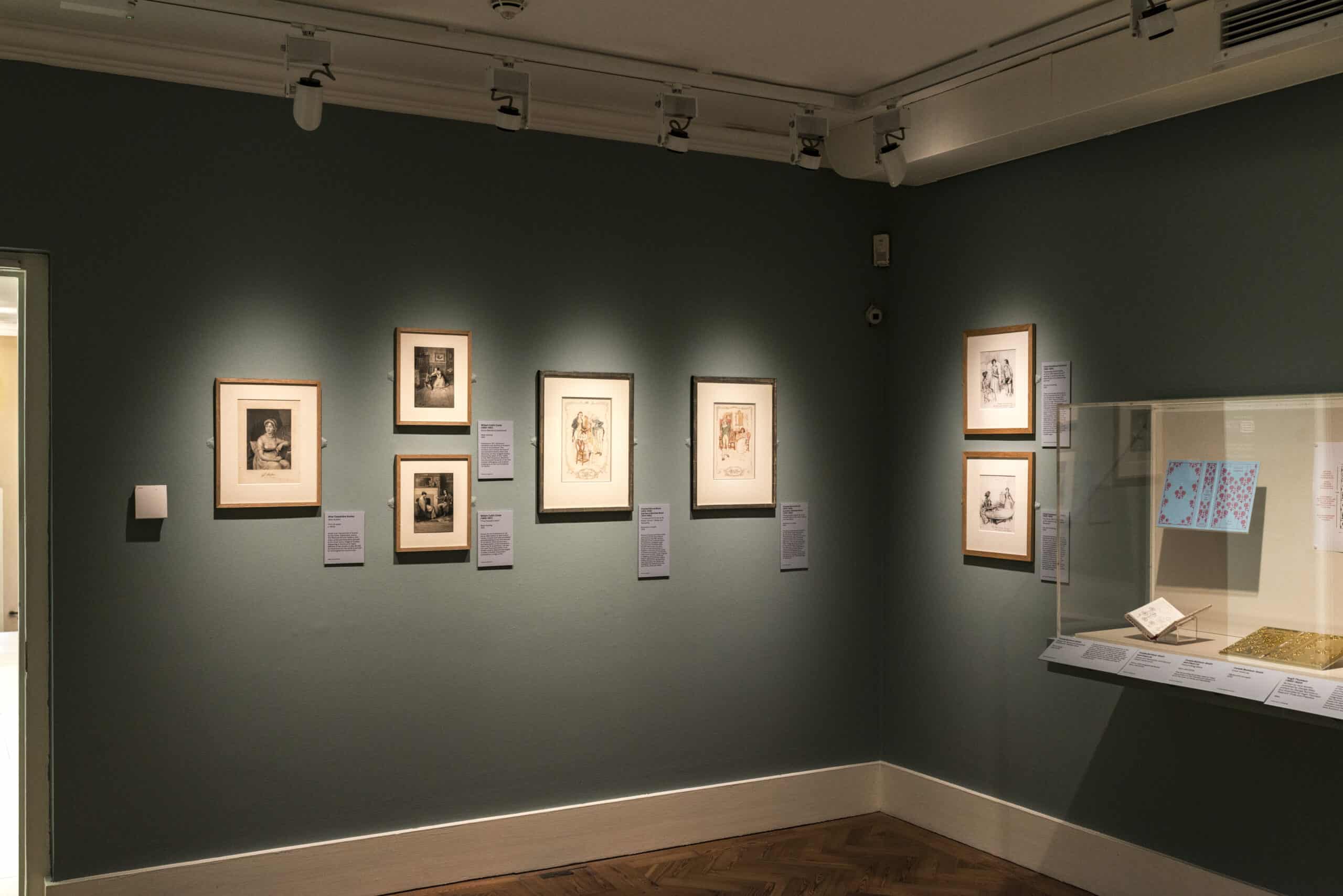 Image on green walls inside the Holburne's Illustrating Austen exhibition, with a glass case to the right