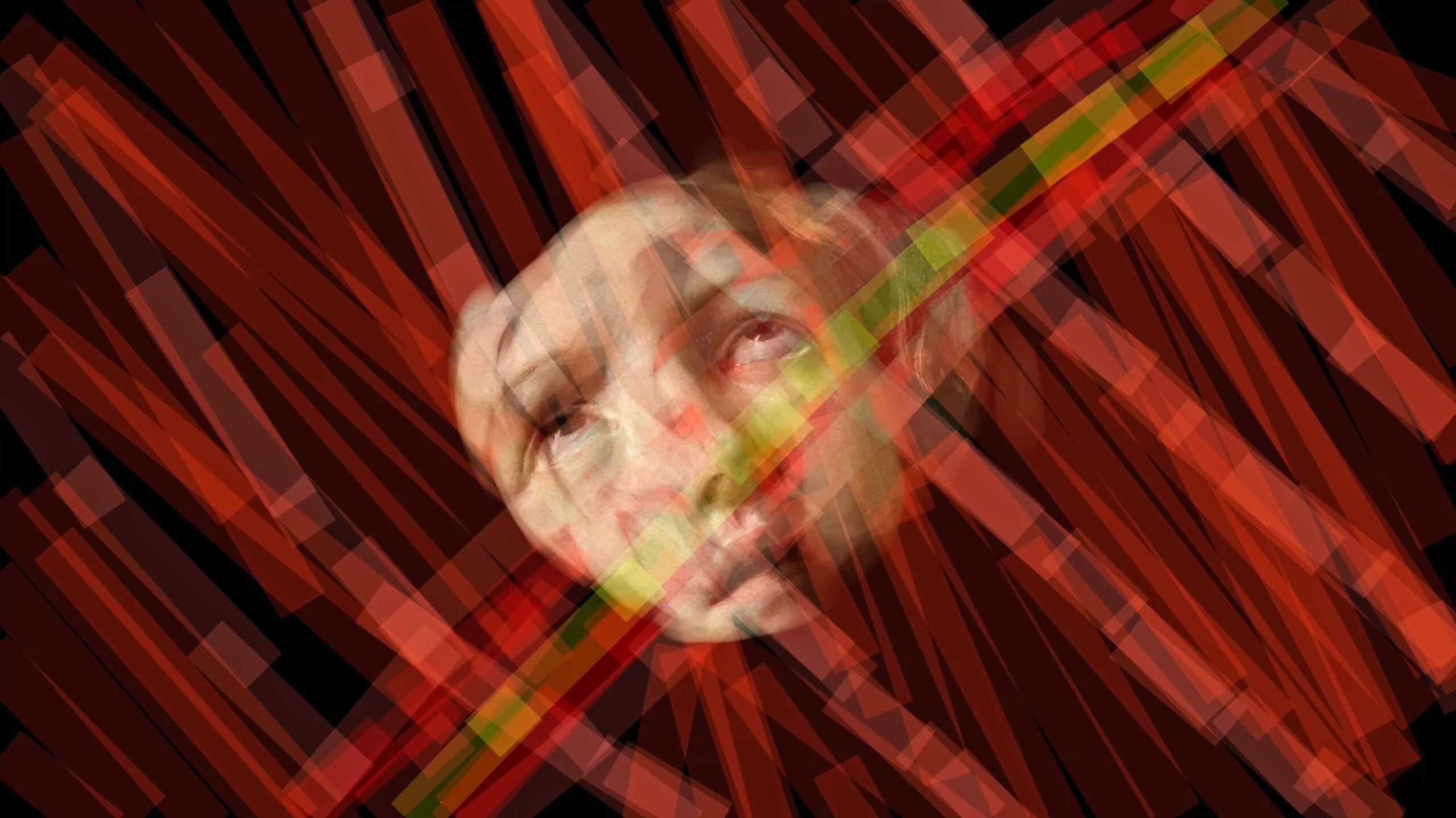 A face emerging from may red layers