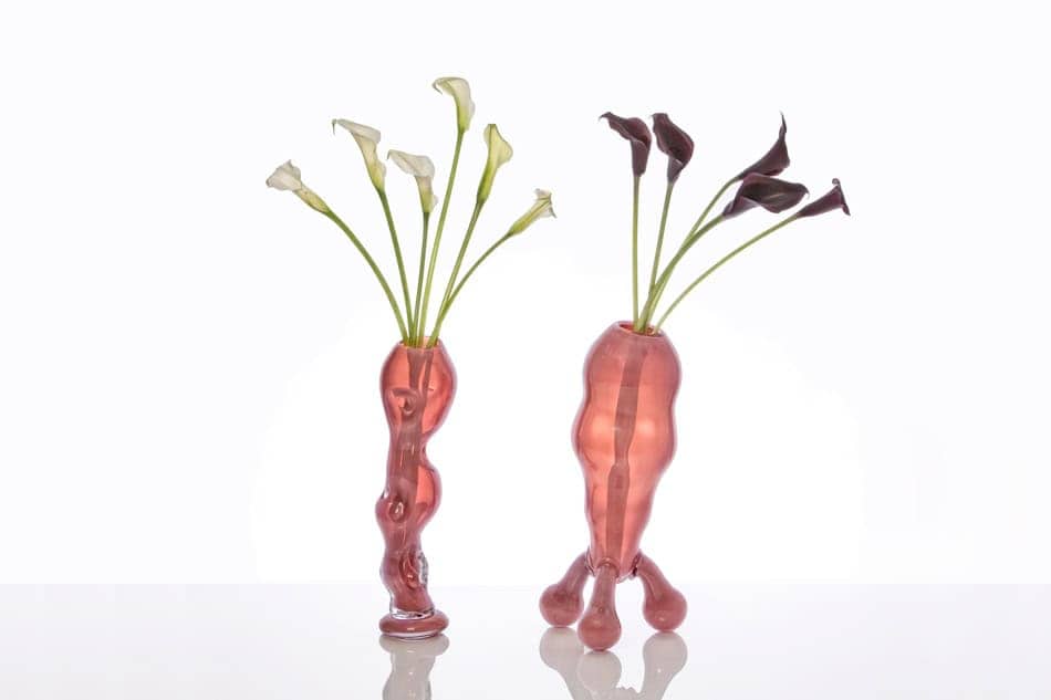 A picture of two orange vases holding lilies, meant to represent a man and a woman