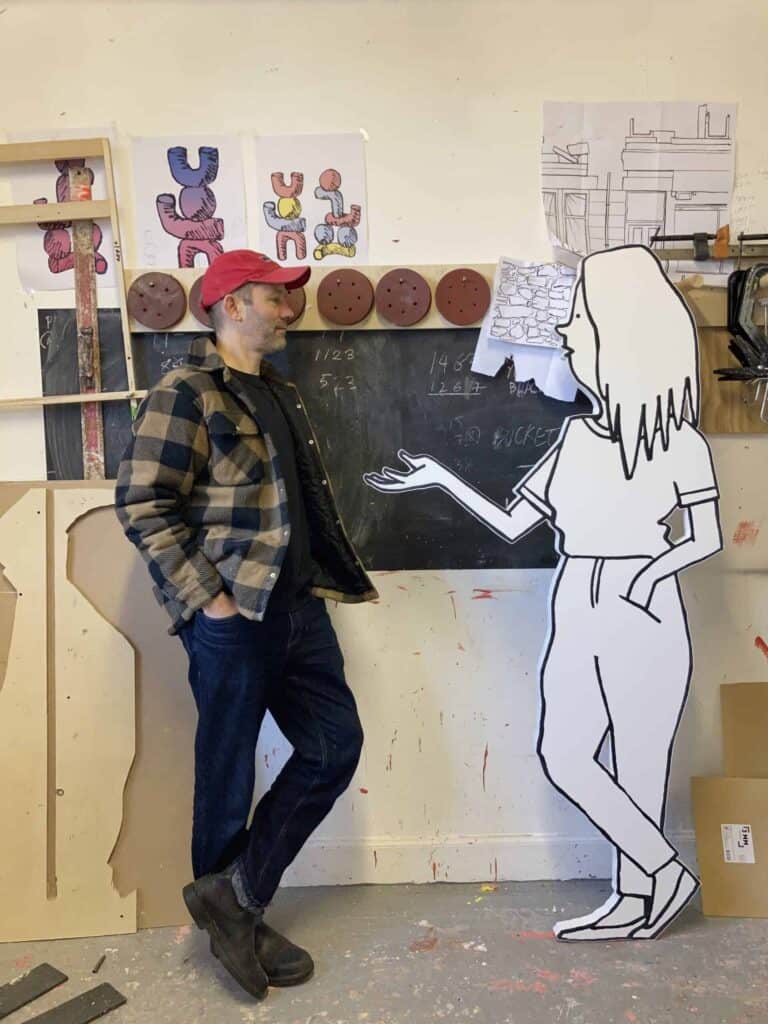 Mick Peter standing my a cartoon cut out having a conversation