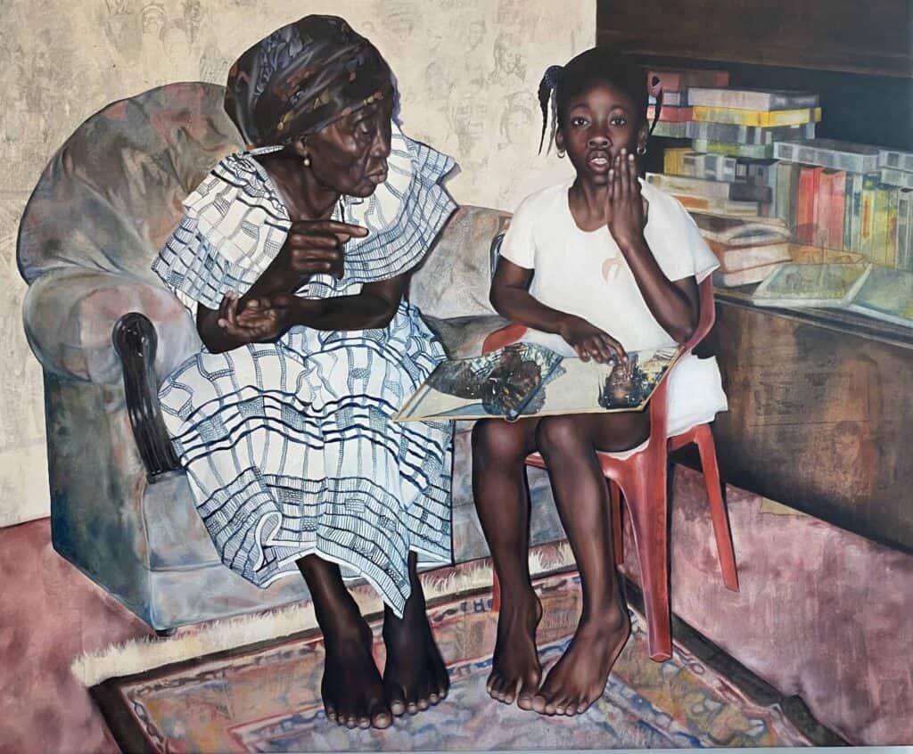 A grandmother sitting on a sofa next to a child on a chair staring out at the camera, with a photograph album on her lap