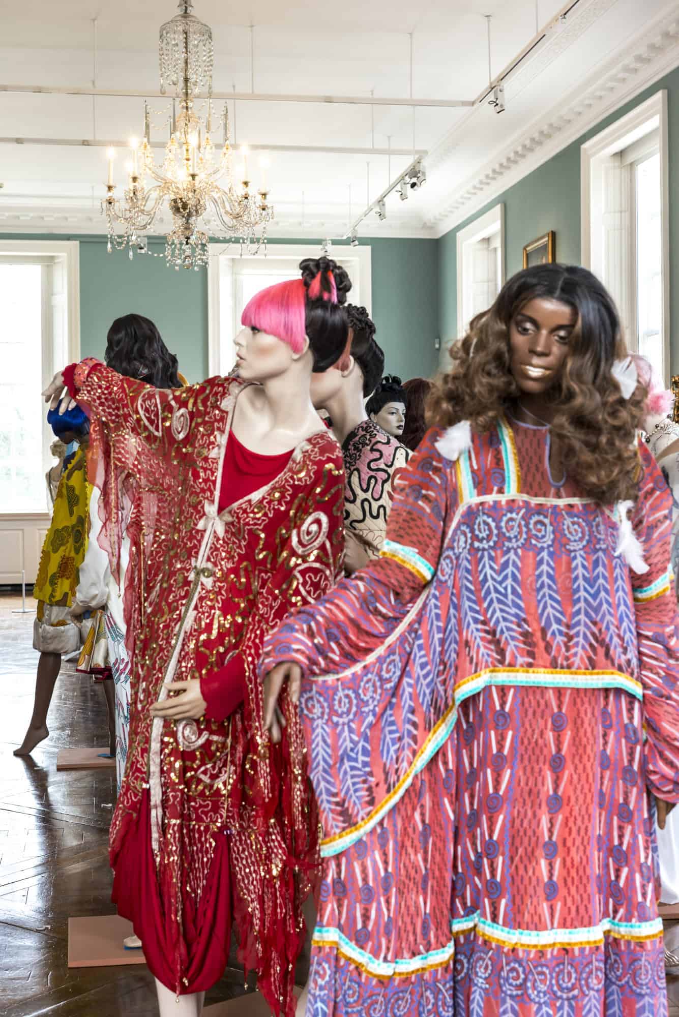 Mannequins wearing clothes designed by Zandra Rhodes positioned with brightly coloured wigs in the Holburne ballroom