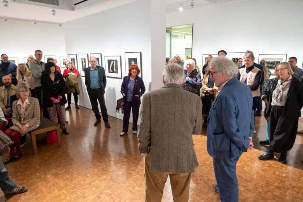 Photo showing a group of people gathered in the gallery for an artist's talk