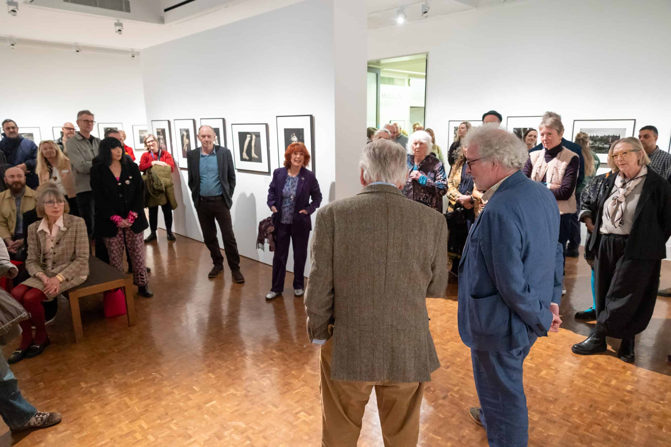Photo showing a group of people gathered in the gallery for an artist's talk