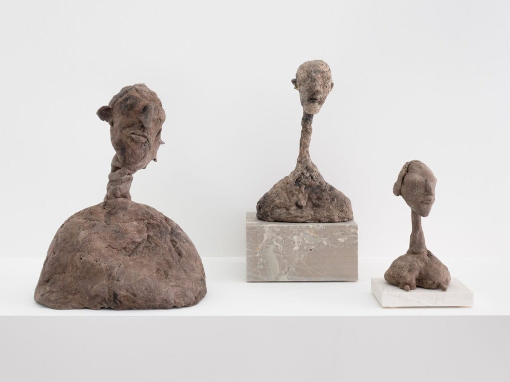 Photo showing three sculptural heads
