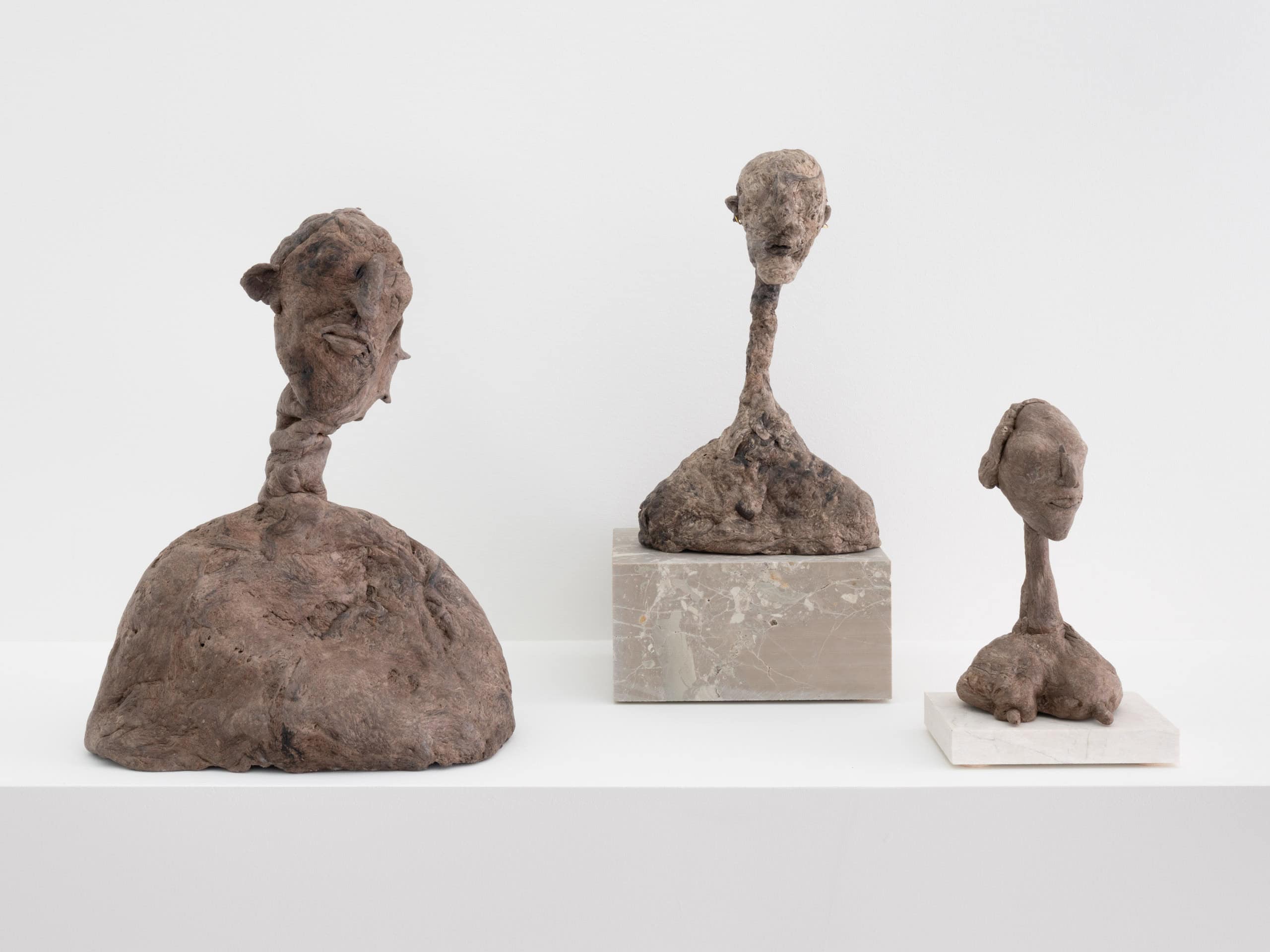 Photo showing three sculptural heads