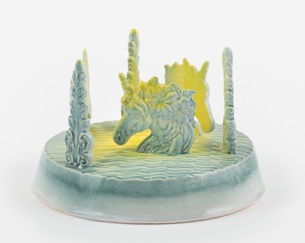 Photo of a glazed ceramic plinth featuring a blue unicorn's head
